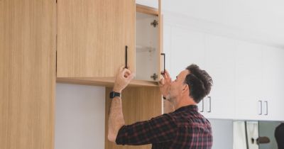 Matt inspecting a cupboard